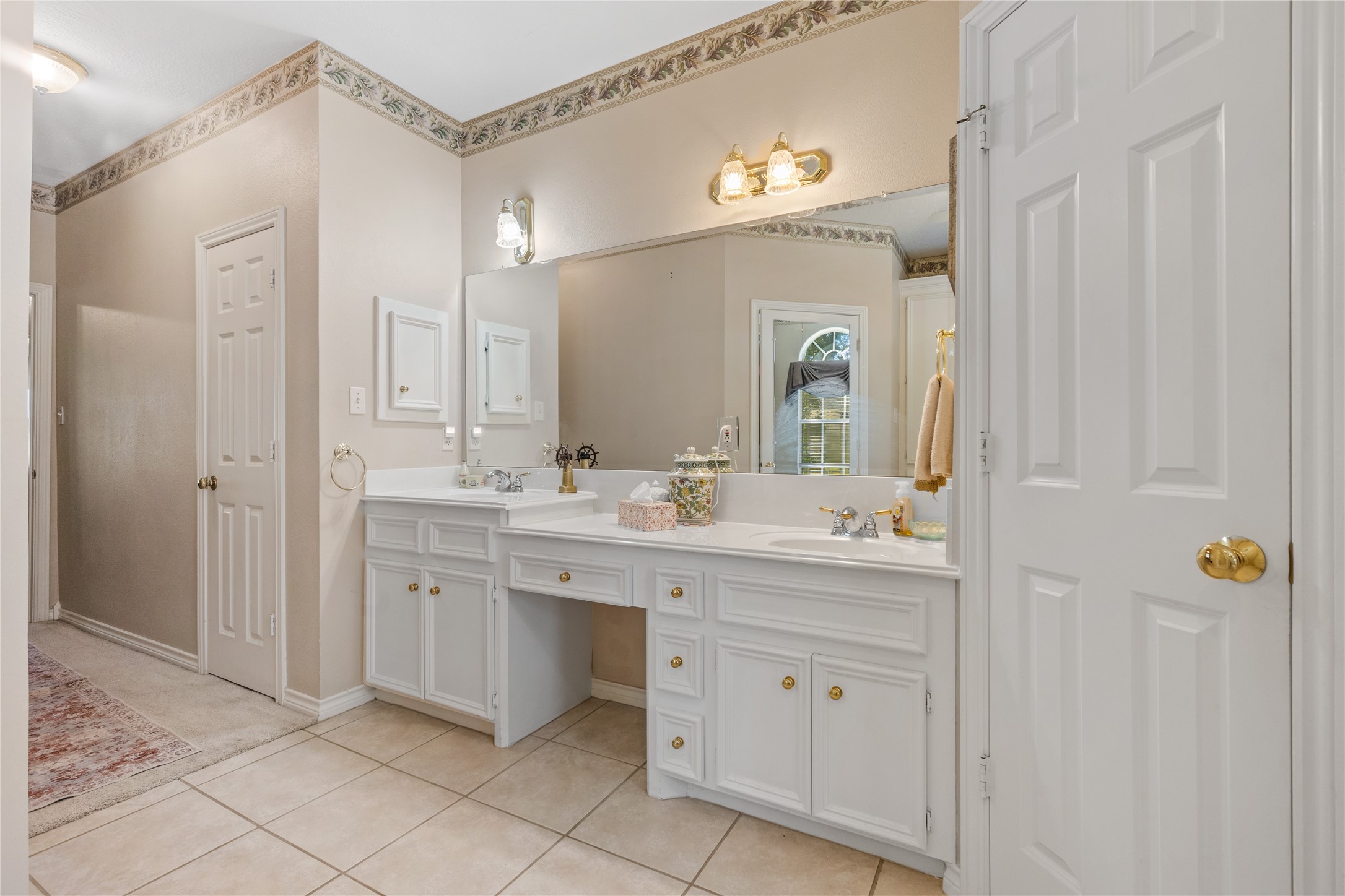 319 Palais Verde Road Montgomery, TX 77356 - Photo 20 of 39 a spacious bathroom with a granite countertop sink and a mirror