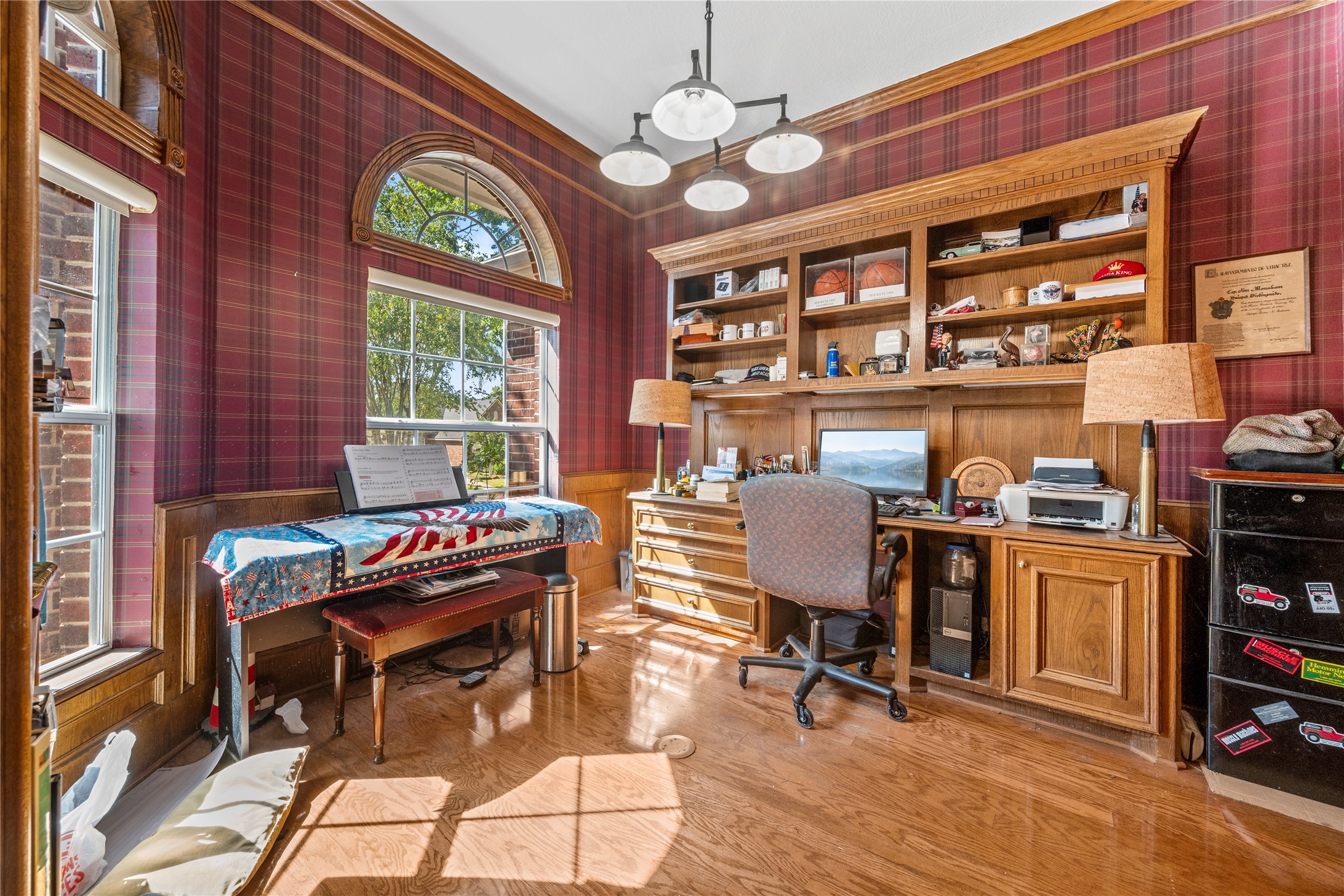 319 Palais Verde Road Montgomery, TX 77356 - Photo 6 of 39 This cozy and regal home office features rich wood accents and built-in shelving. Large arched windows provide plenty of natural light, complementing the warm, patterned walls. An inviting space for work and creativity.