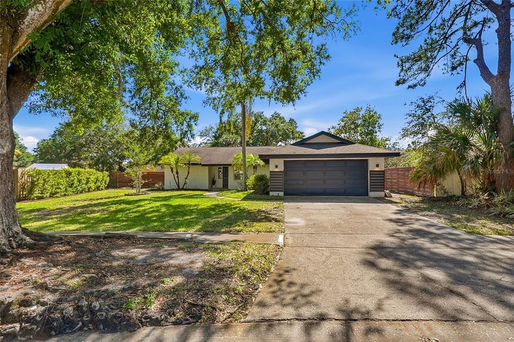4606 Buckeye Road Tampa, FL 33624 - Photo 37 of 39 a front view of a house with a yard and a garage