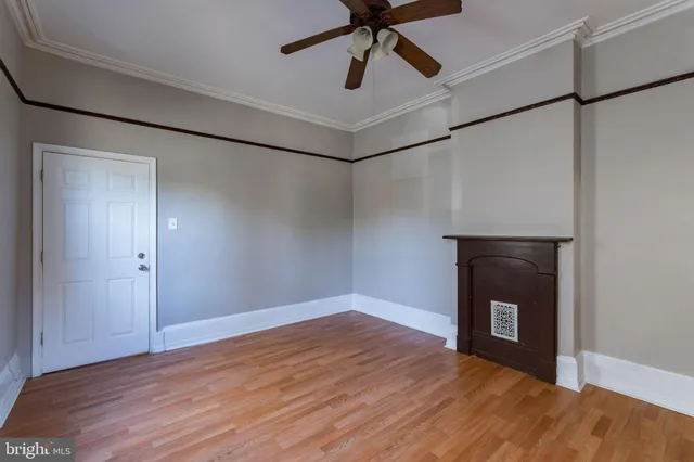 a view of a livingroom with a fireplace and wooden floor