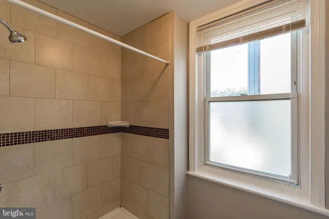 a bathroom with a glass shower door