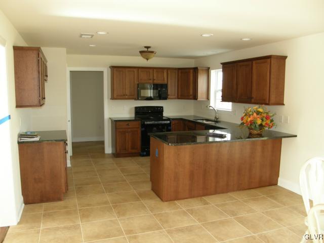 233 East Dell Road Bath, PA 18014 - Photo 2 of 13 a kitchen with stainless steel appliances granite countertop a stove a sink a refrigerator and a cabinets