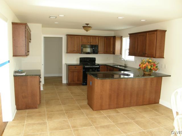 233 East Dell Road Bath, PA 18014 - Photo 5 of 13 a kitchen with stainless steel appliances granite countertop a sink and cabinets
