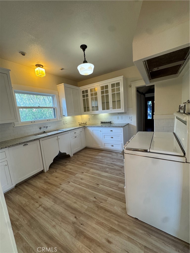 4478 4th Street Riverside, CA 92501 - Photo 14 of 51 a kitchen with a stove and a wooden floors