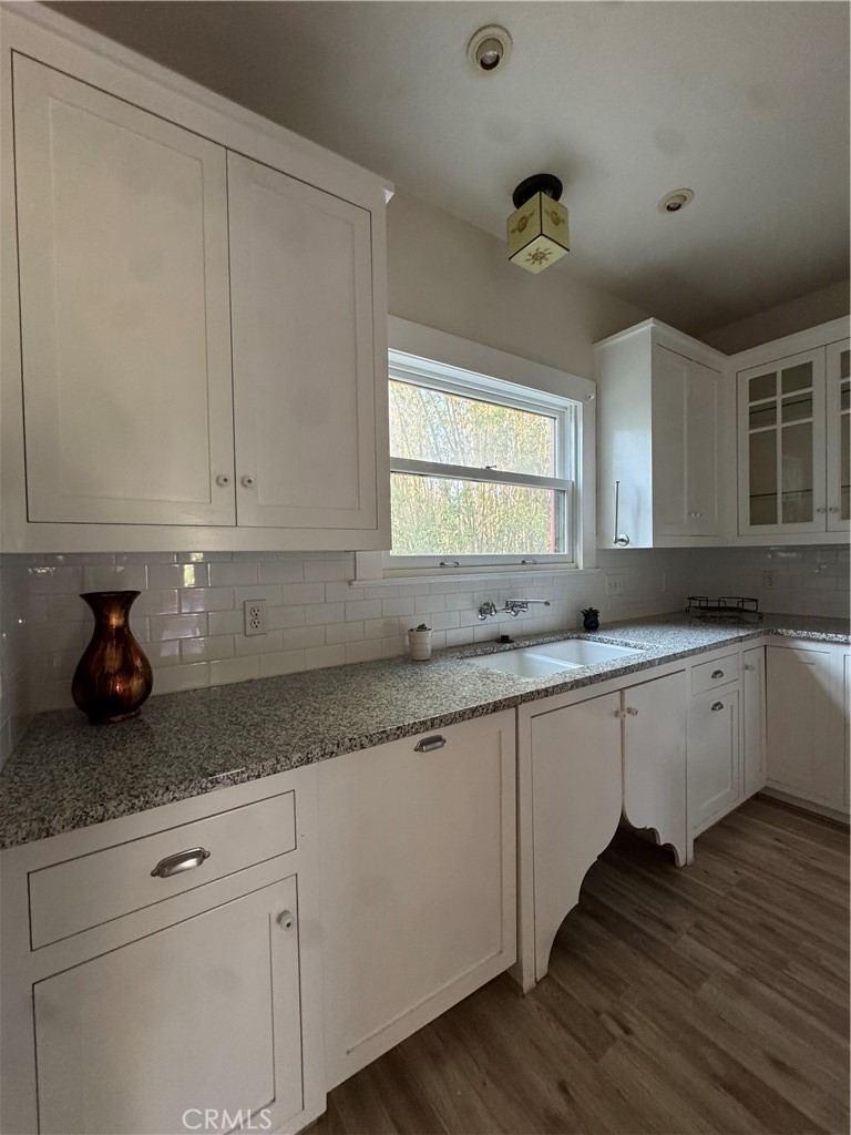 4478 4th Street Riverside, CA 92501 - Photo 15 of 51 a kitchen with granite countertop white cabinets white appliances and a granite counter tops