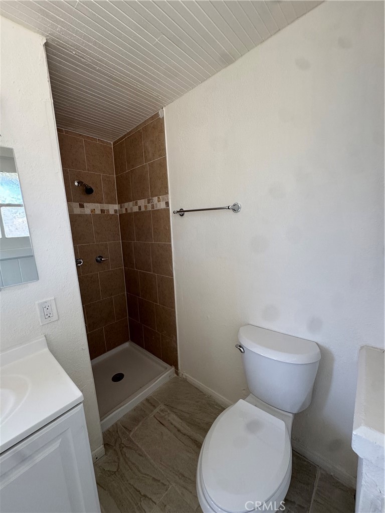 4478 4th Street Riverside, CA 92501 - Photo 21 of 51 a white toilet sitting next to a shower