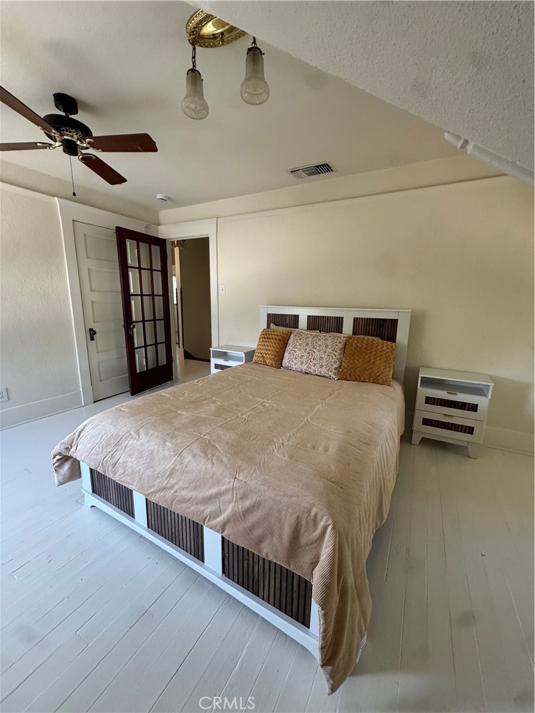 4478 4th Street Riverside, CA 92501 - Photo 24 of 51 a large bed sitting in a room next to a window