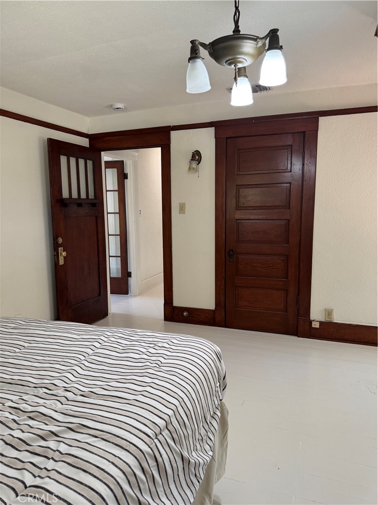 4478 4th Street Riverside, CA 92501 - Photo 26 of 51 a bedroom with a bed and a chandelier