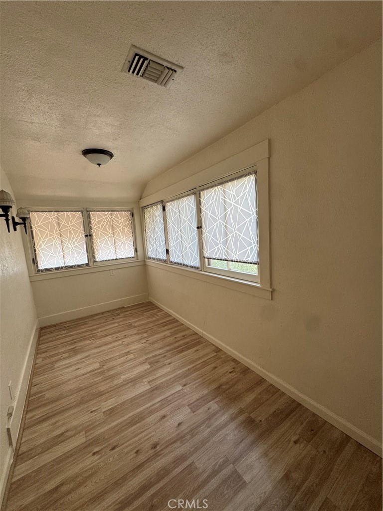 4478 4th Street Riverside, CA 92501 - Photo 30 of 51 a view of an empty room with wooden floor and a window