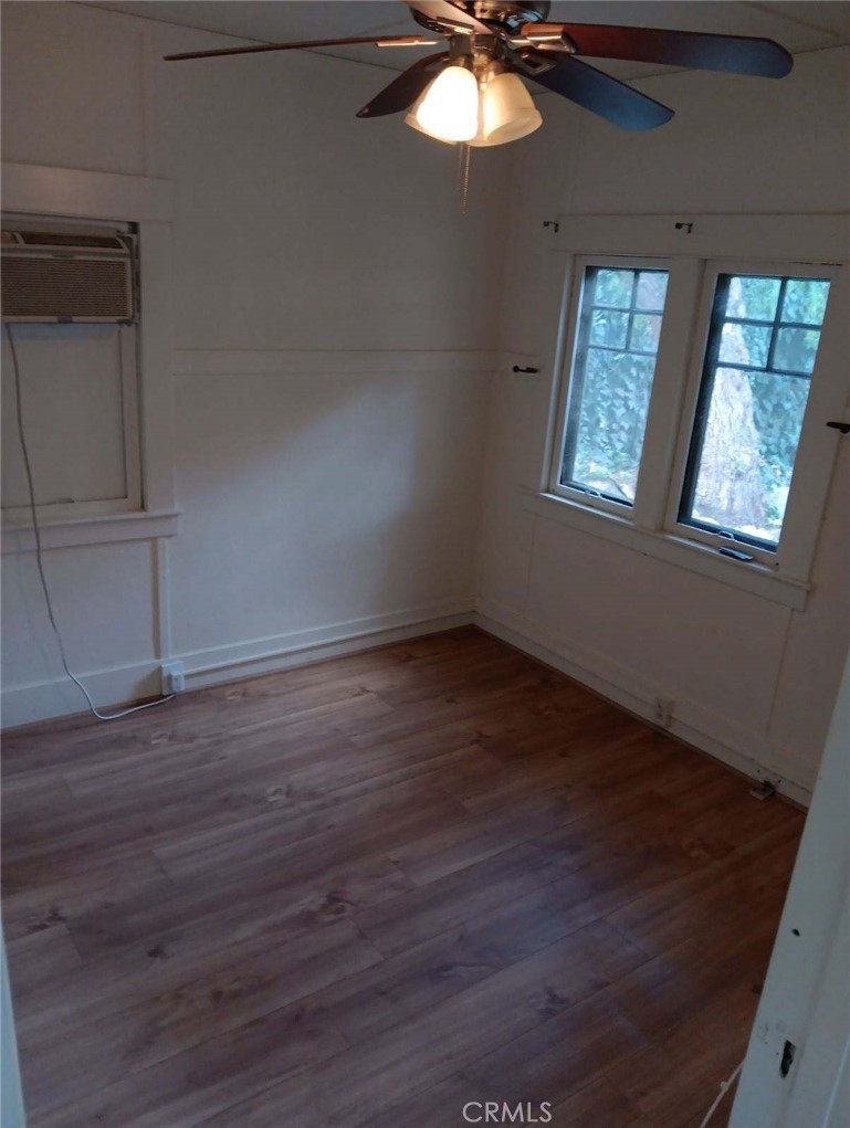 4478 4th Street Riverside, CA 92501 - Photo 43 of 51 an empty room with wooden floor fan and windows
