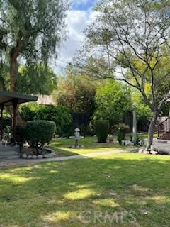 4478 4th Street Riverside, CA 92501 - Photo 47 of 51 a view of a swimming pool with lawn chairs and plants