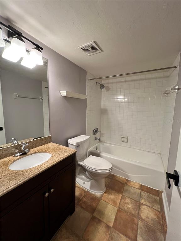 2360 Southwest Archer Road, Unit 719 Gainesville, FL 32608 - Photo 12 of 15 a bathroom with a sink a toilet and shower