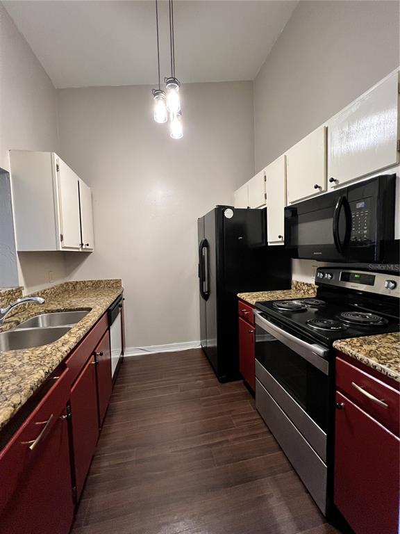 2360 Southwest Archer Road, Unit 719 Gainesville, FL 32608 - Photo 15 of 15 a kitchen with stainless steel appliances granite countertop a stove and a refrigerator