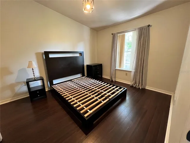 a bedroom with bed and window
