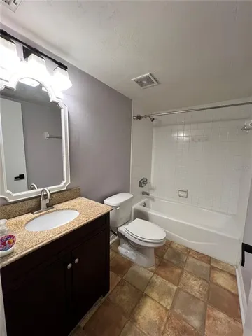 a bathroom with a double vanity sink toilet mirror and shower