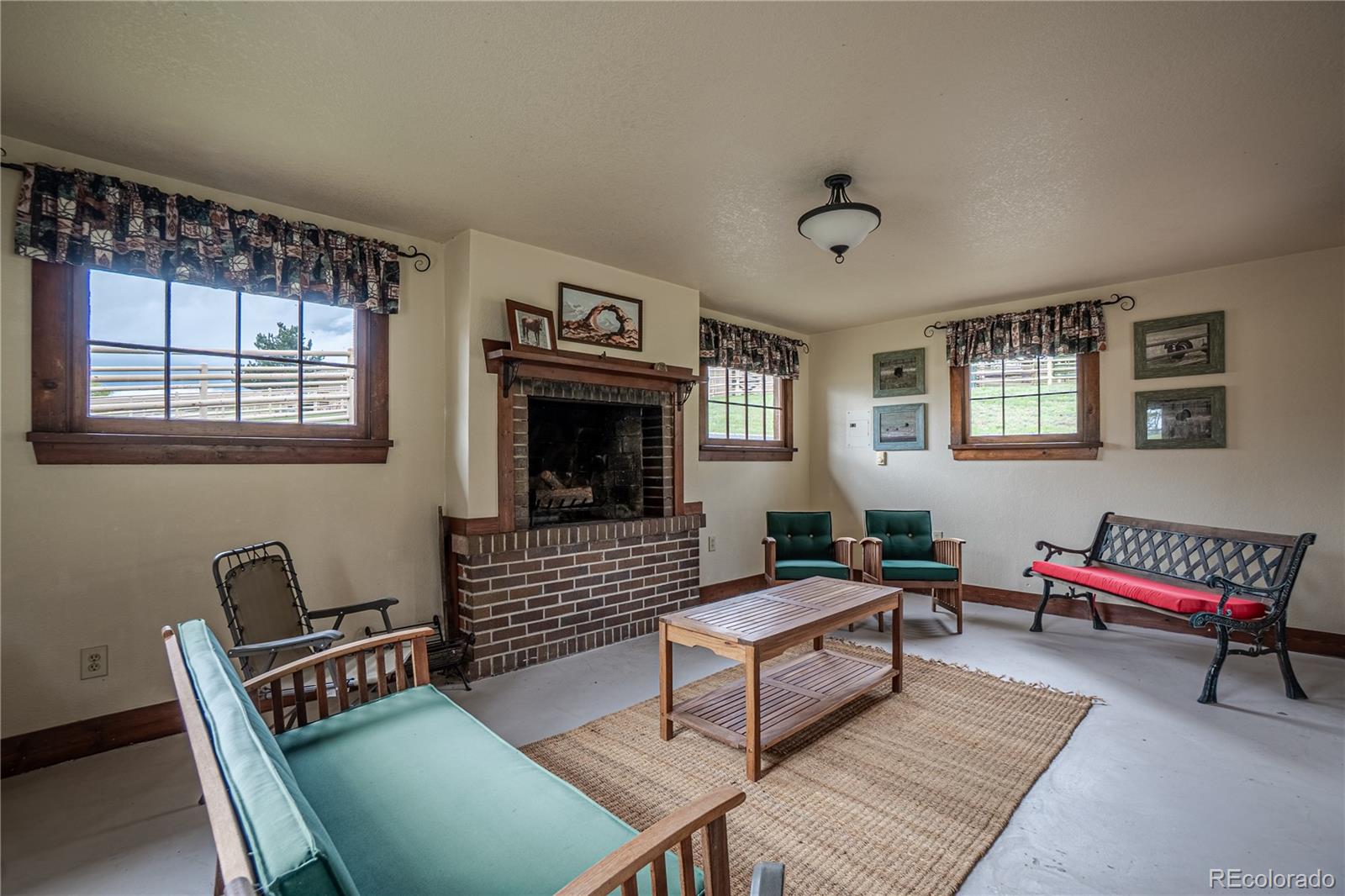 3282 Tomah Road Larkspur, CO 80118 - Photo 35 of 35 a living room with furniture and a window