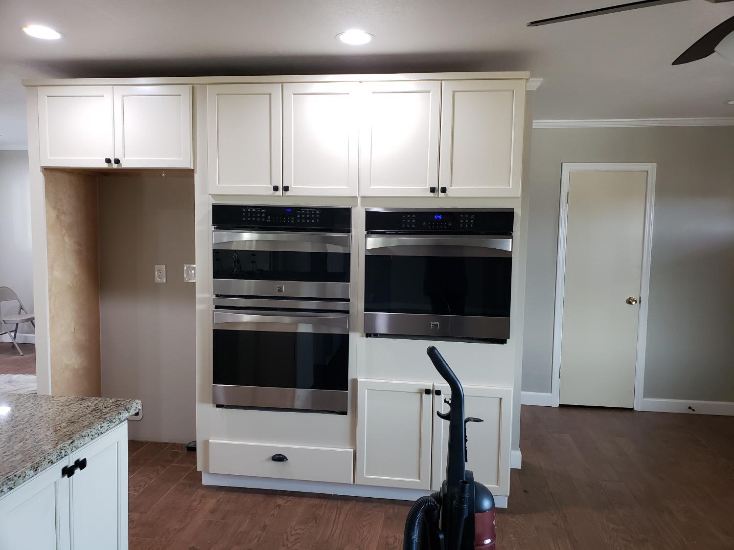 5658 Road 28 Madera, CA 93637 - Photo 3 of 11 a kitchen with granite countertop white cabinets and stainless steel appliances