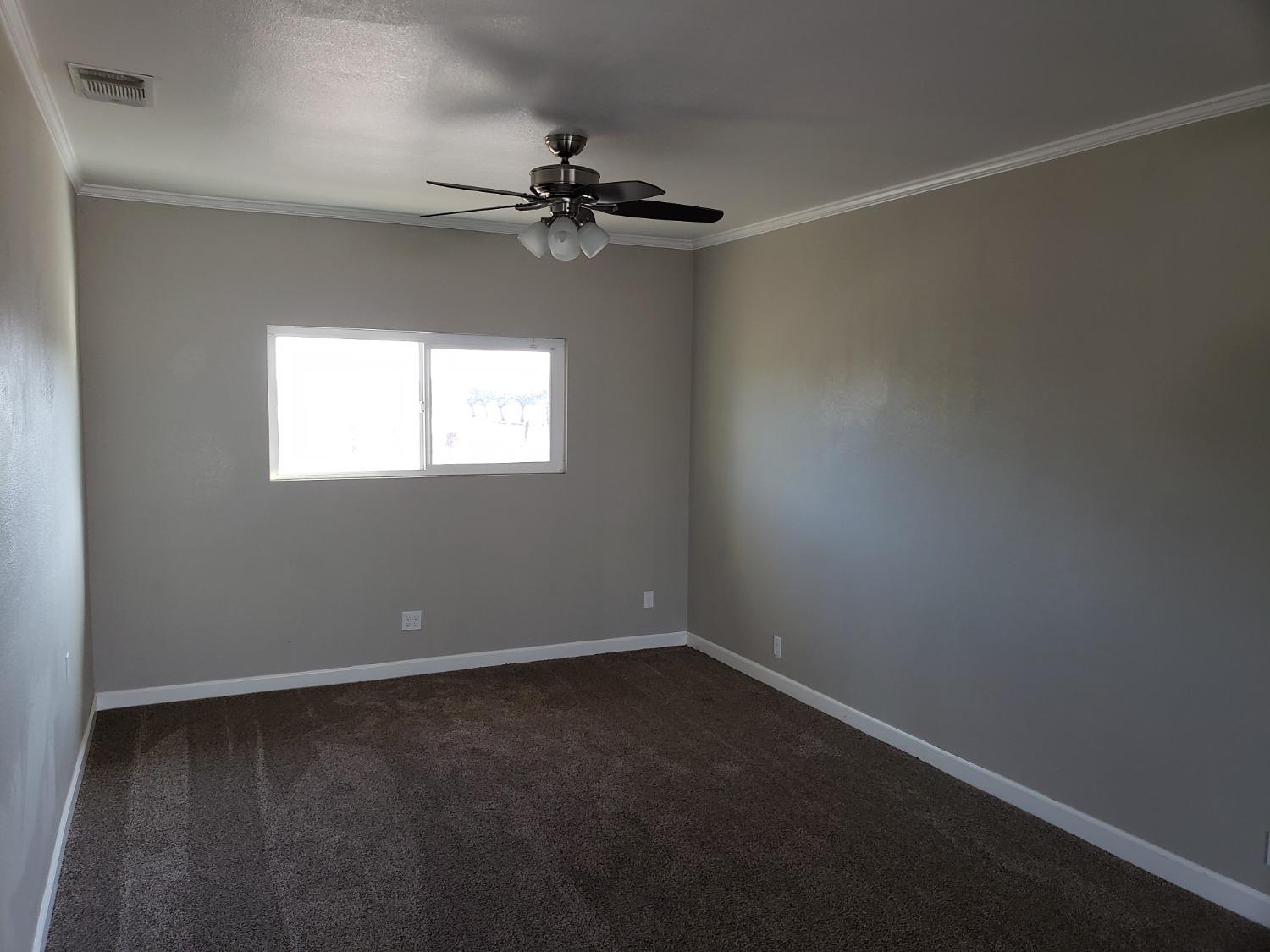 5658 Road 28 Madera, CA 93637 - Photo 4 of 11 an empty room with a window and a fan