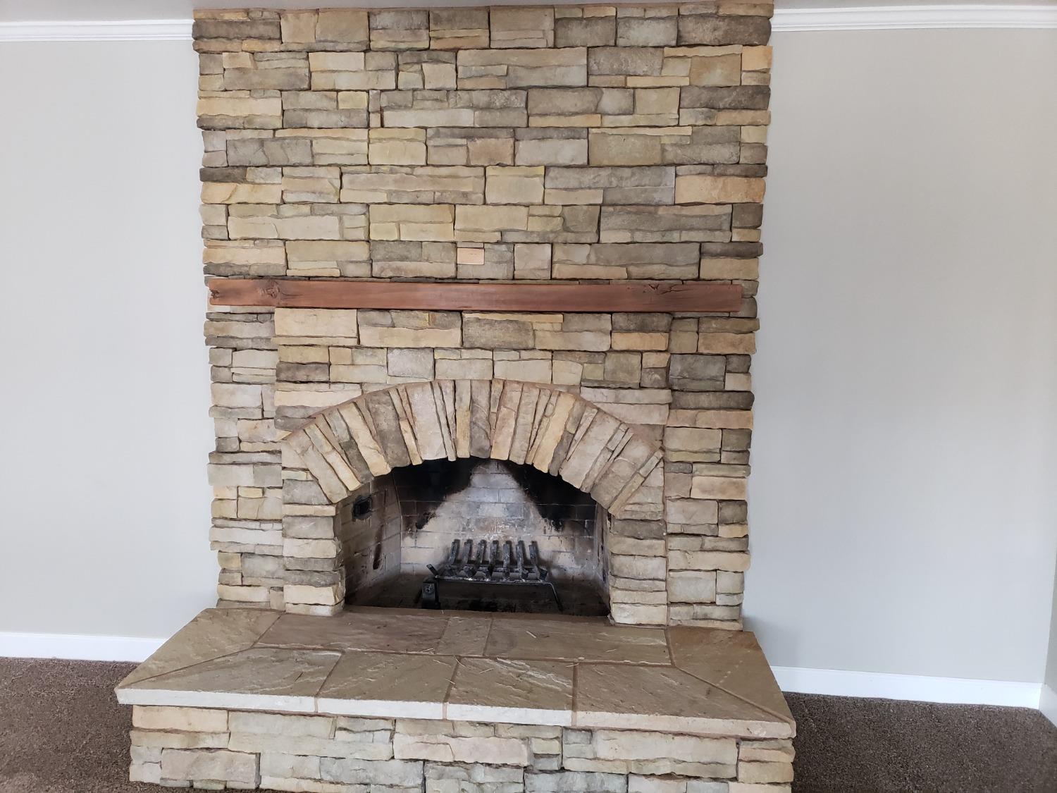 5658 Road 28 Madera, CA 93637 - Photo 9 of 11 a fireplace with a clock on wall