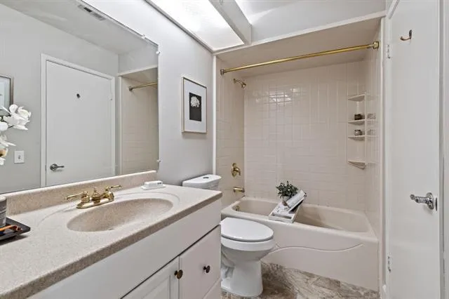 a bathroom with a sink toilet a mirror and shower