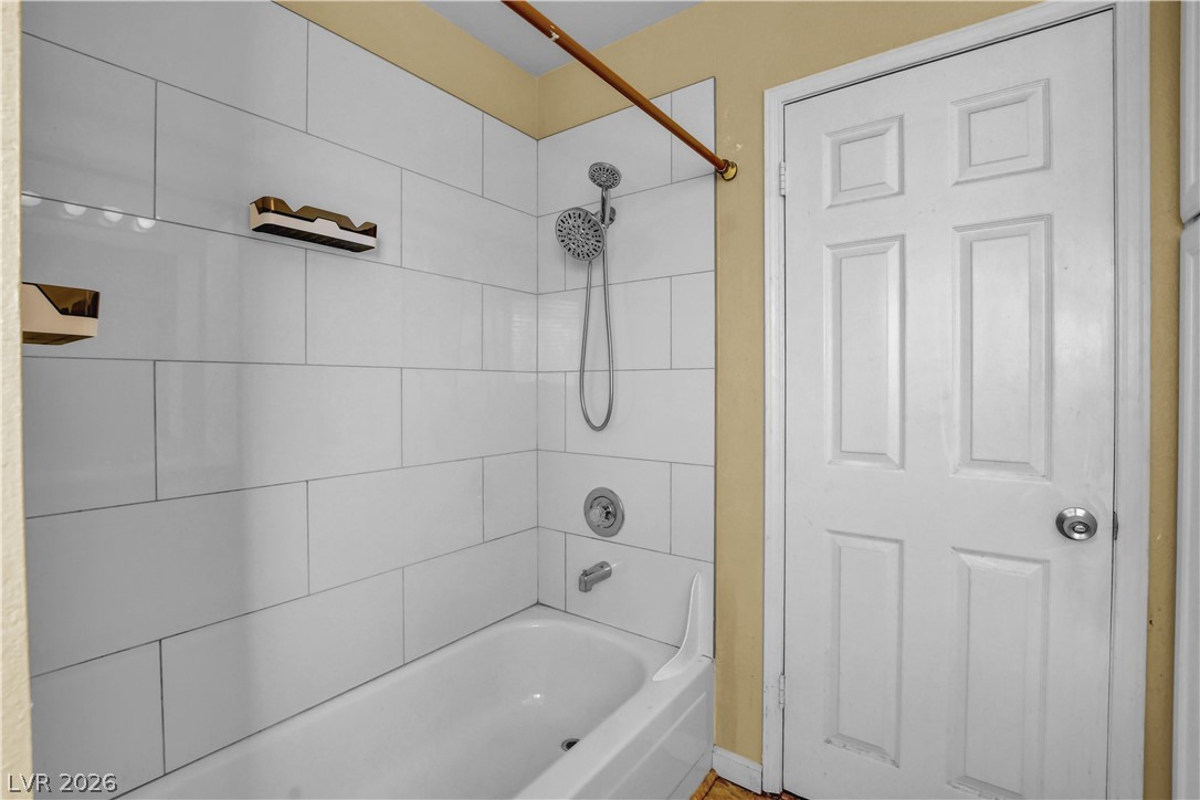 6440 Hartwood Road Las Vegas, NV 89108 - Photo 33 of 59 Clean white subway tile surrounds this inviting bath and shower combination.