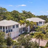 a front view of a house with a yard and fountain