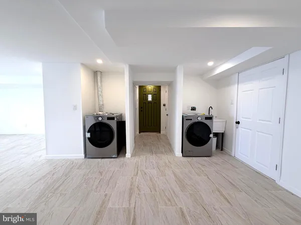 a view of a kitchen with a washer and dryer