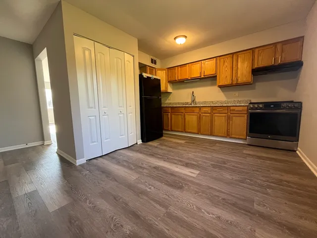 a view of a kitchen with a sink and a stove top oven