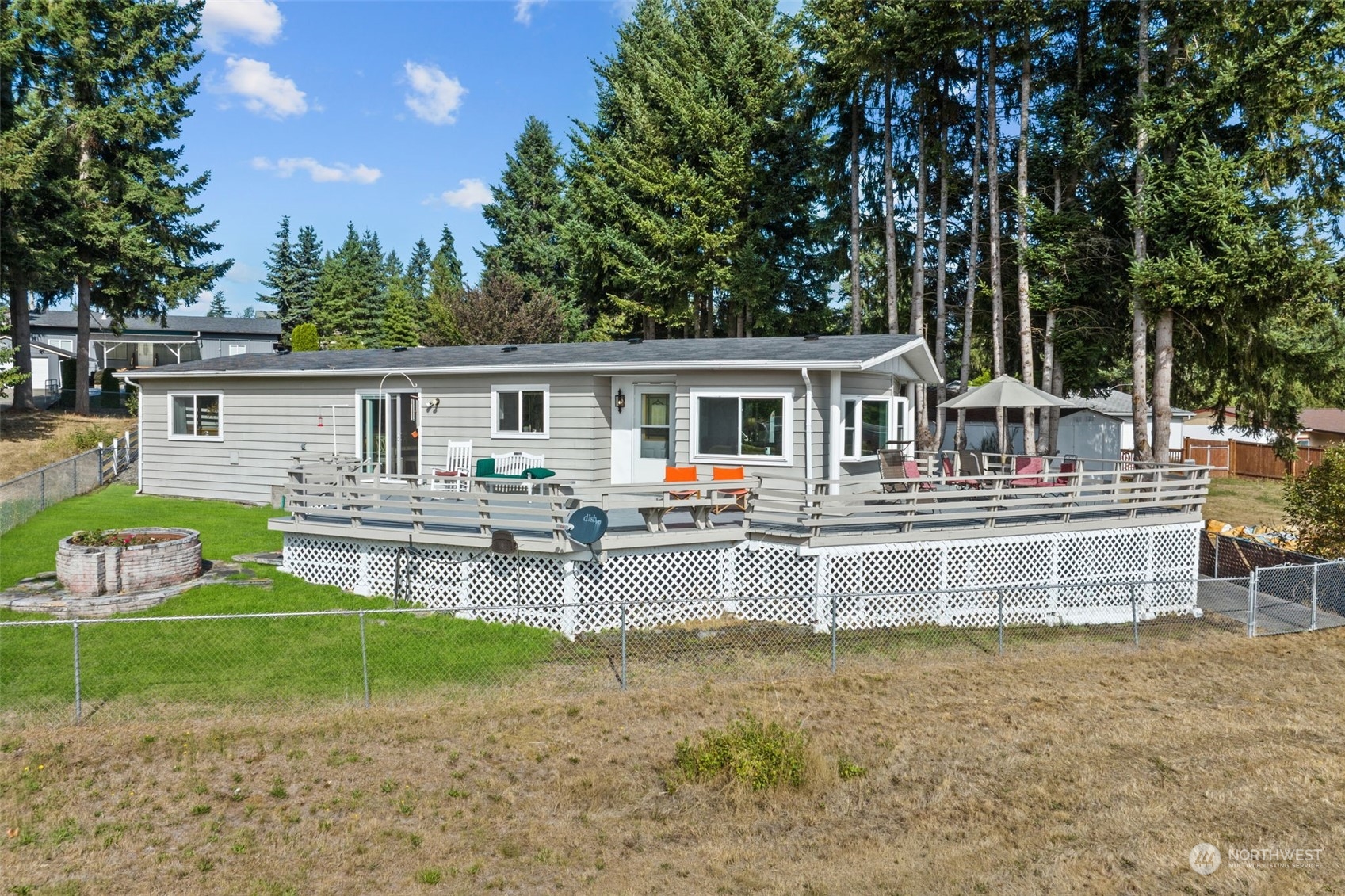 13909 Prairie Ridge Drive East Bonney Lake, WA 98391 - Photo 32 of 36 a view of house with a big yard and large trees