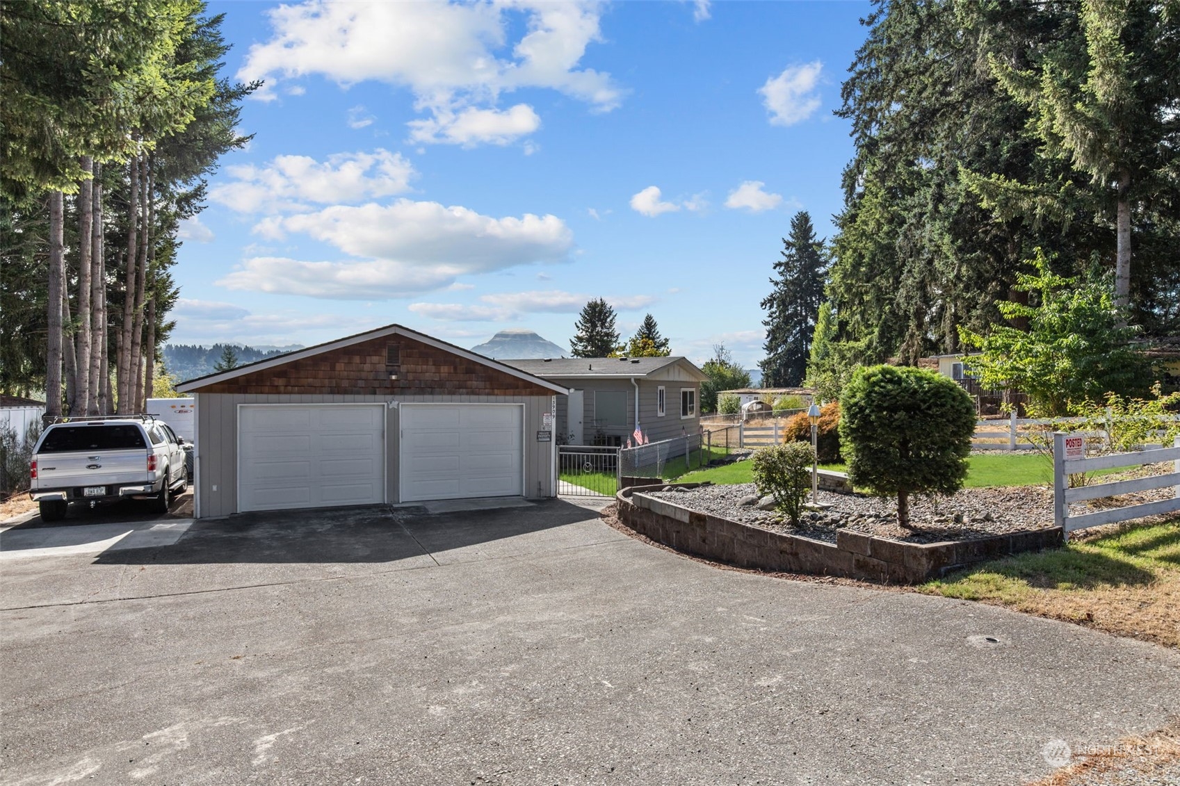 13909 Prairie Ridge Drive East Bonney Lake, WA 98391 - Photo 34 of 36 a view of a house with a yard and garage