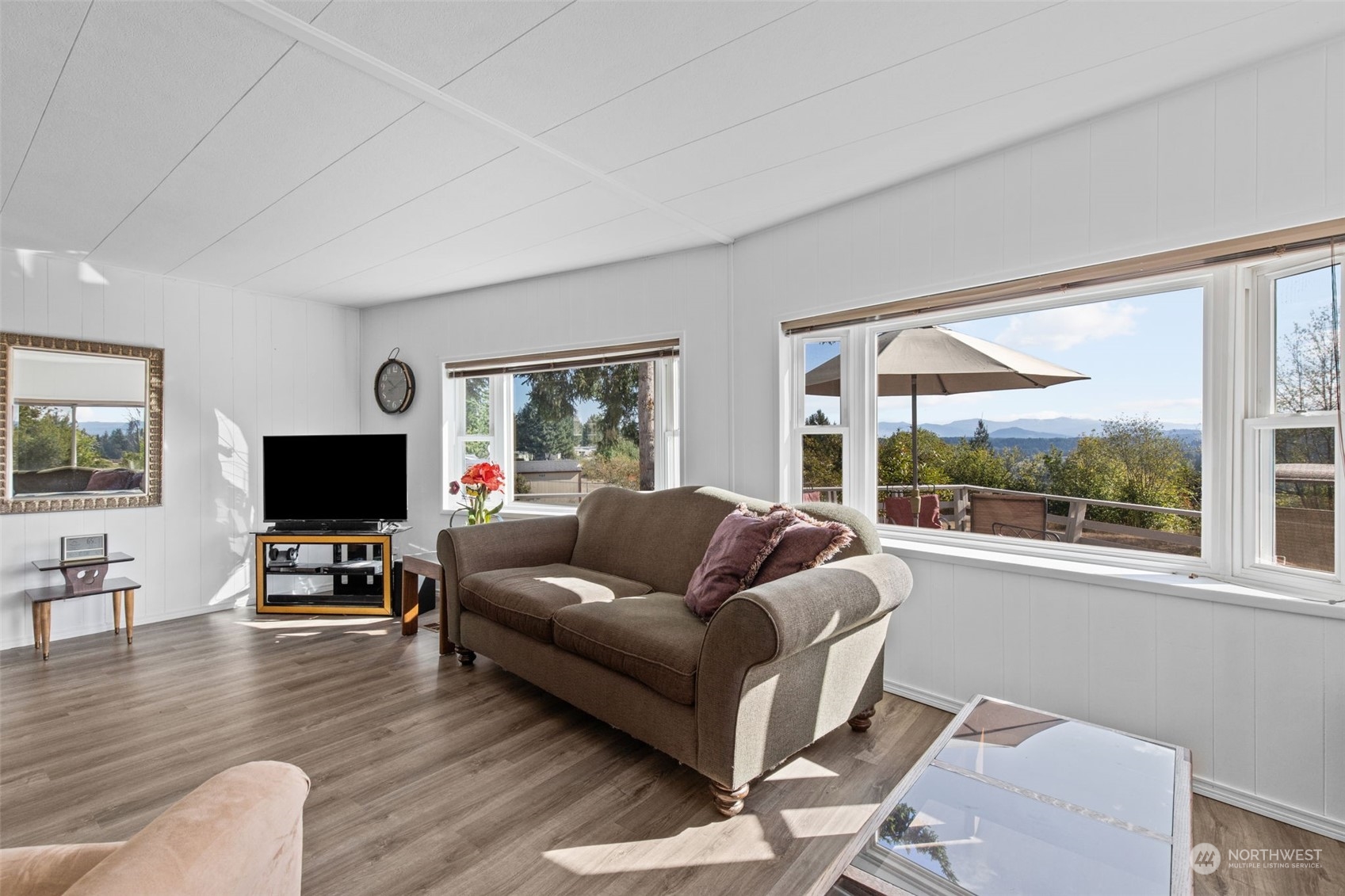 13909 Prairie Ridge Drive East Bonney Lake, WA 98391 - Photo 4 of 36 a living room with furniture and a flat screen tv