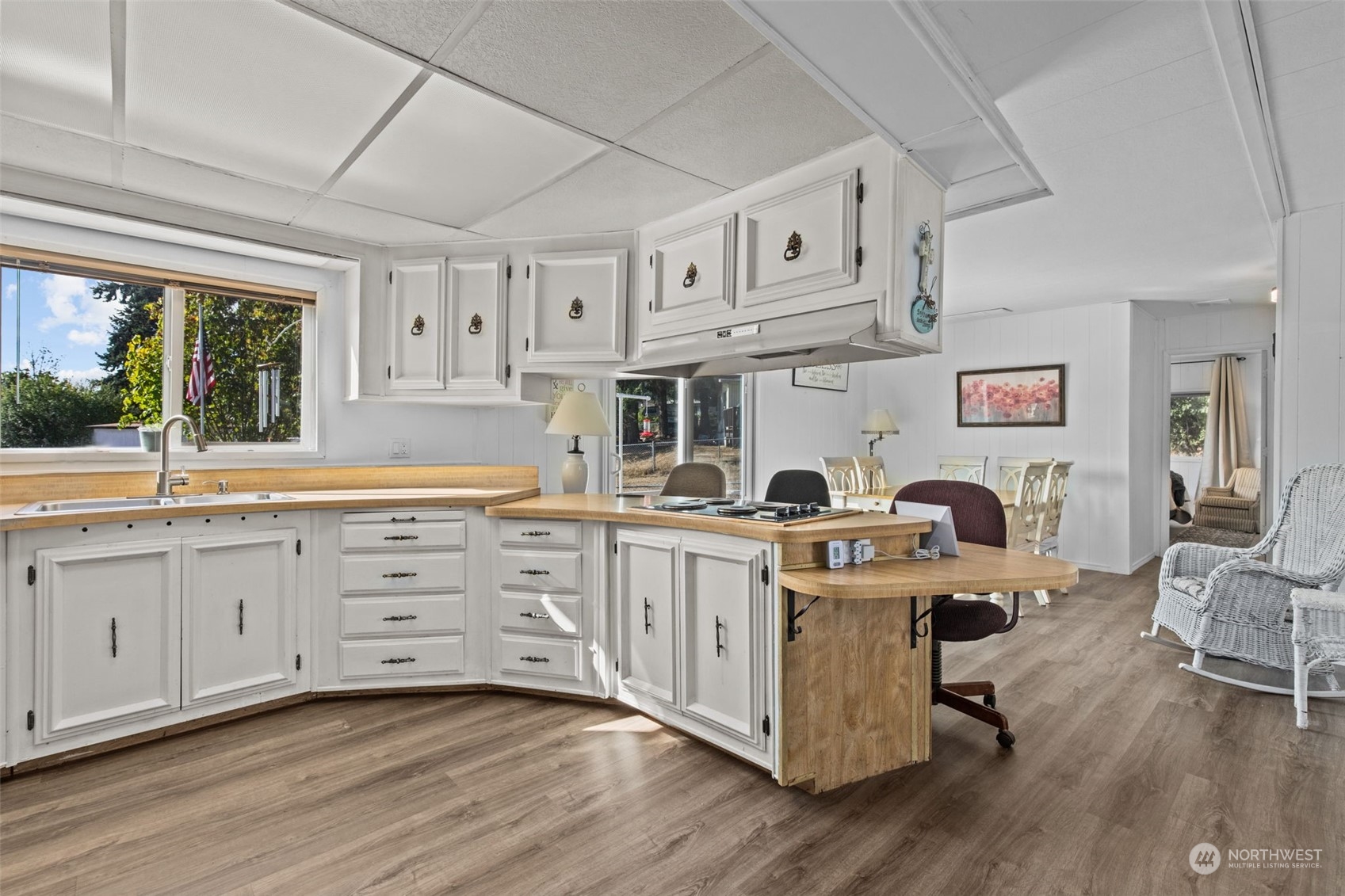 13909 Prairie Ridge Drive East Bonney Lake, WA 98391 - Photo 8 of 36 a kitchen with stainless steel appliances granite countertop a stove a sink dishwasher and white cabinets with wooden floor