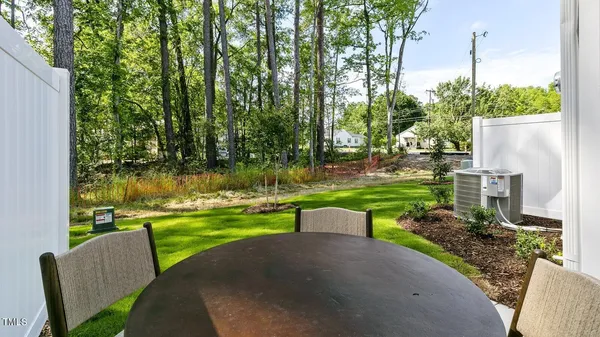 a view of a house with patio and a yard