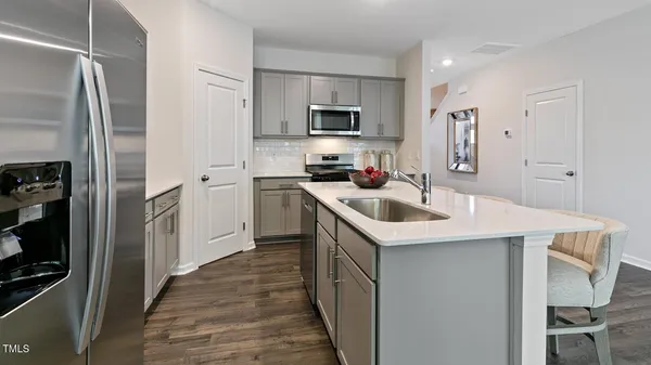 a kitchen with a sink a stove and refrigerator