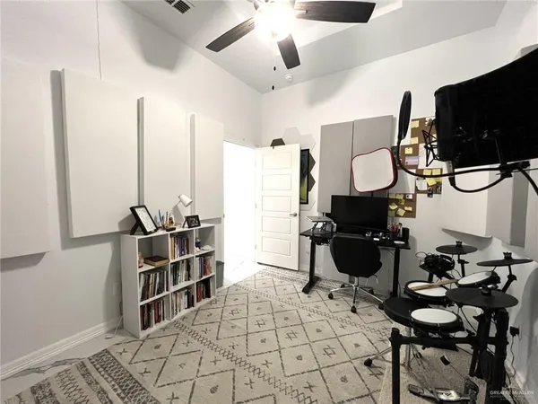a living room with furniture a flat screen tv and kitchen view