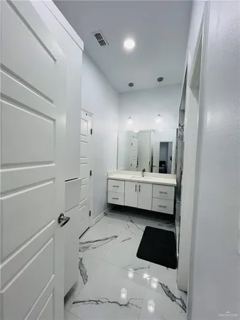 a bathroom with a double vanity sink a mirror and a shower