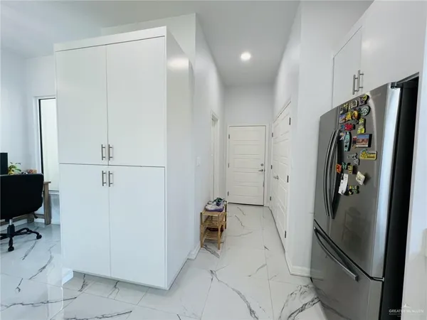 a view of cabinets with refrigerator