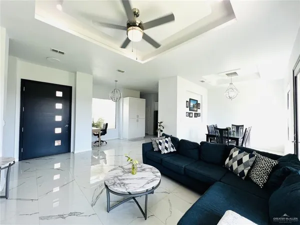 a living room with furniture and a wooden floor