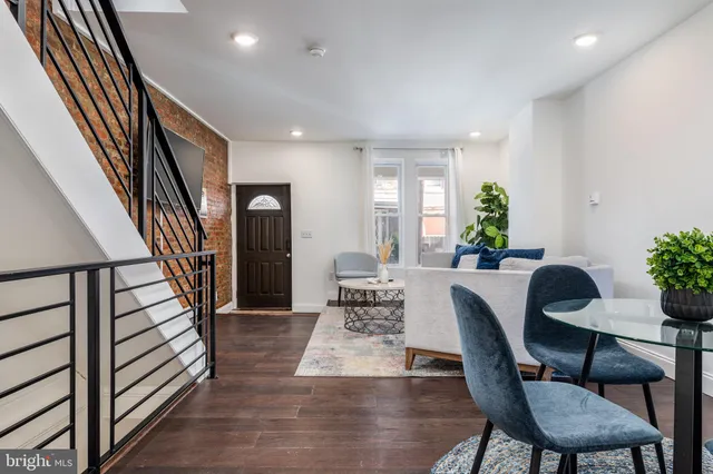 a view of a dining room with furniture and a potted plant