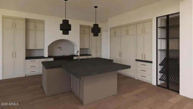 a kitchen with cabinets appliances and a wooden floor
