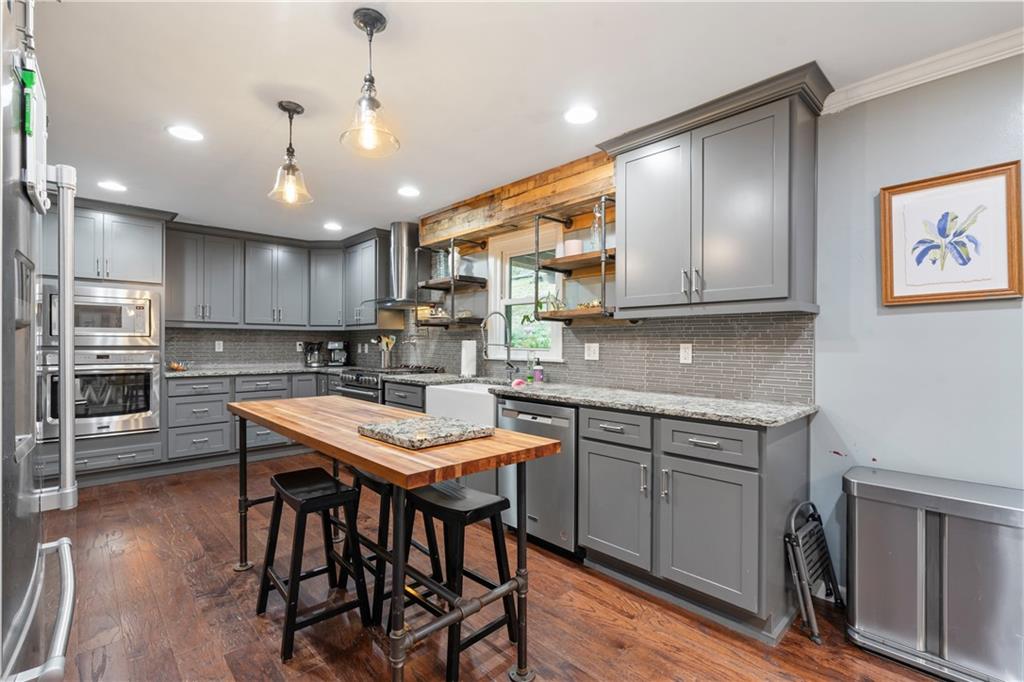 127 Berwyn Road Pittsburgh, PA 15237 - Photo 13 of 29 a kitchen with stainless steel appliances granite countertop a table chairs sink refrigerator and cabinets