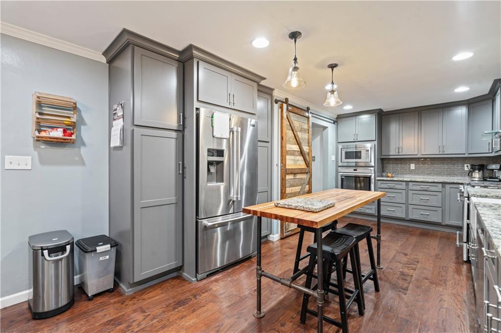 127 Berwyn Road Pittsburgh, PA 15237 - Photo 14 of 29 a kitchen with stainless steel appliances kitchen island granite countertop a refrigerator and a stove top oven