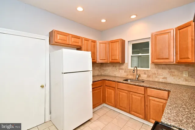 a white refrigerator freezer sitting in a kitchen