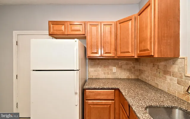 a white refrigerator freezer sitting in a kitchen