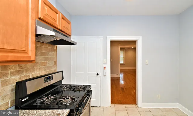 a kitchen with a stove and a refrigerator