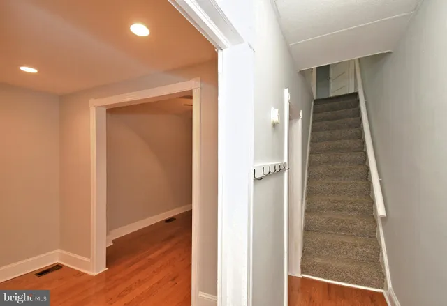 a view of a hallway with wooden floor and entryway