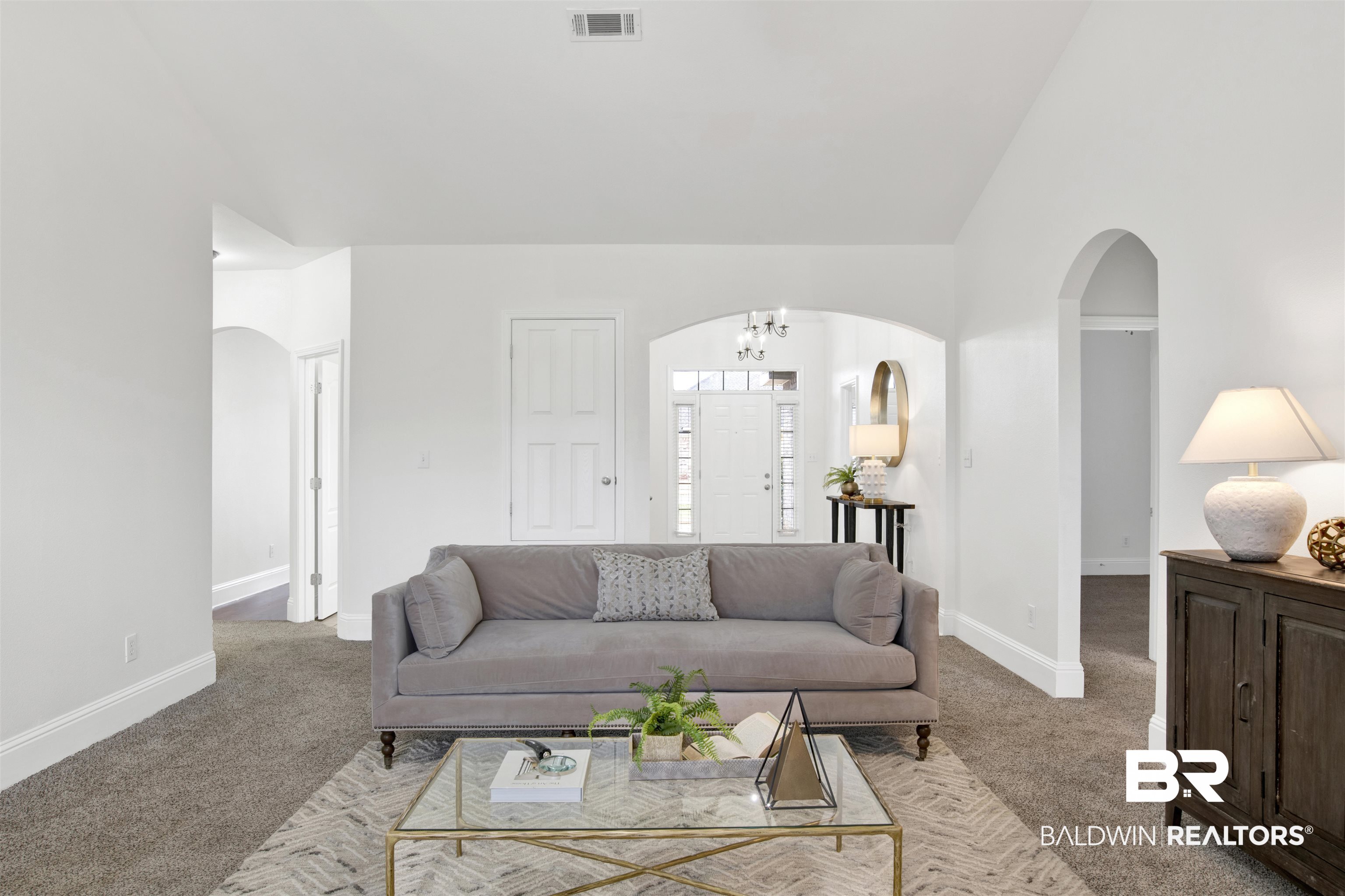 25350 Spindle Lane Daphne, AL 36526 - Photo 10 of 32 Living room with a notable chandelier, light colored carpet, and high vaulted ceiling