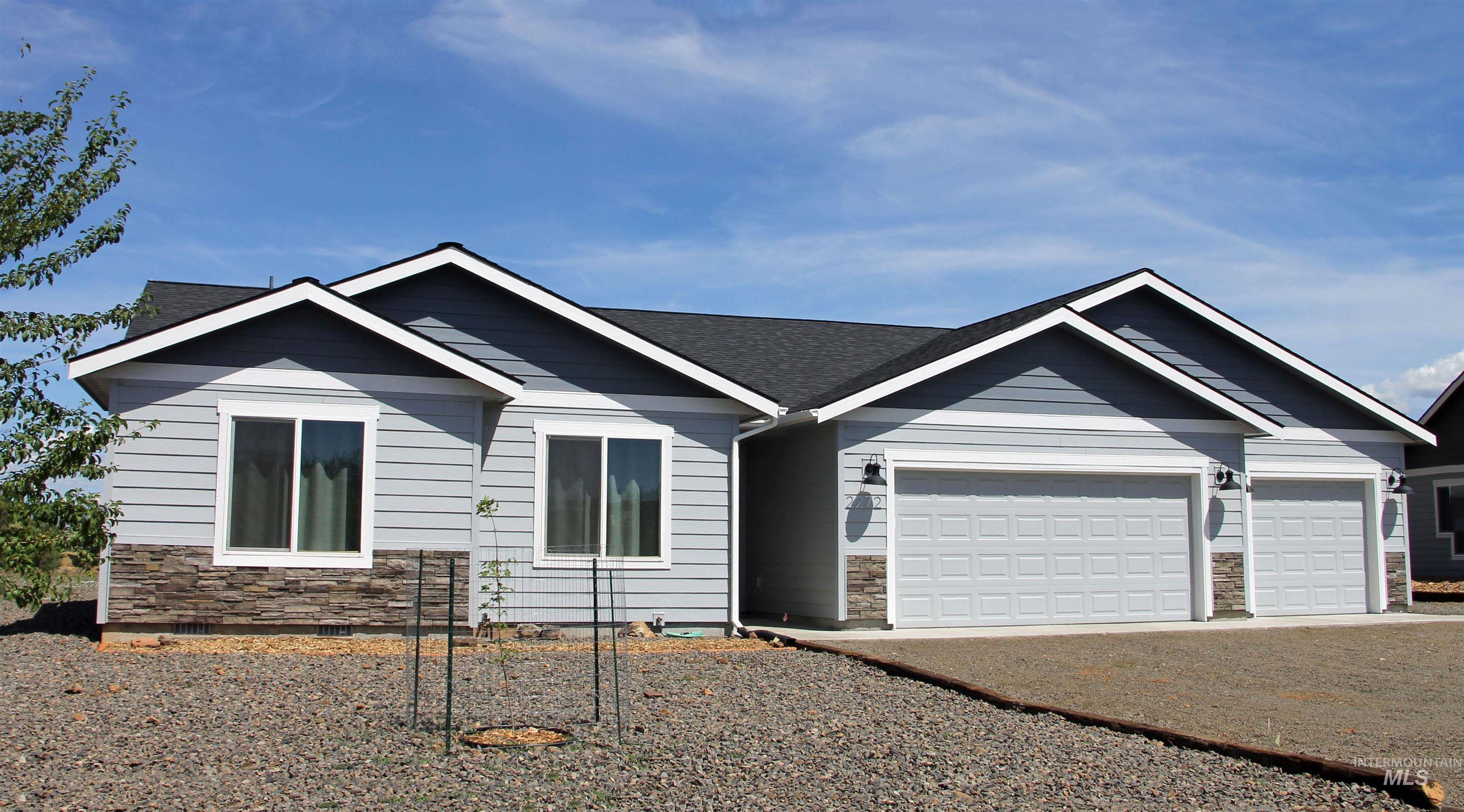 2272 Golf Lane Council, ID 83612 - Photo 1 of 32 Single story home with stone siding, a garage, and gravel driveway
