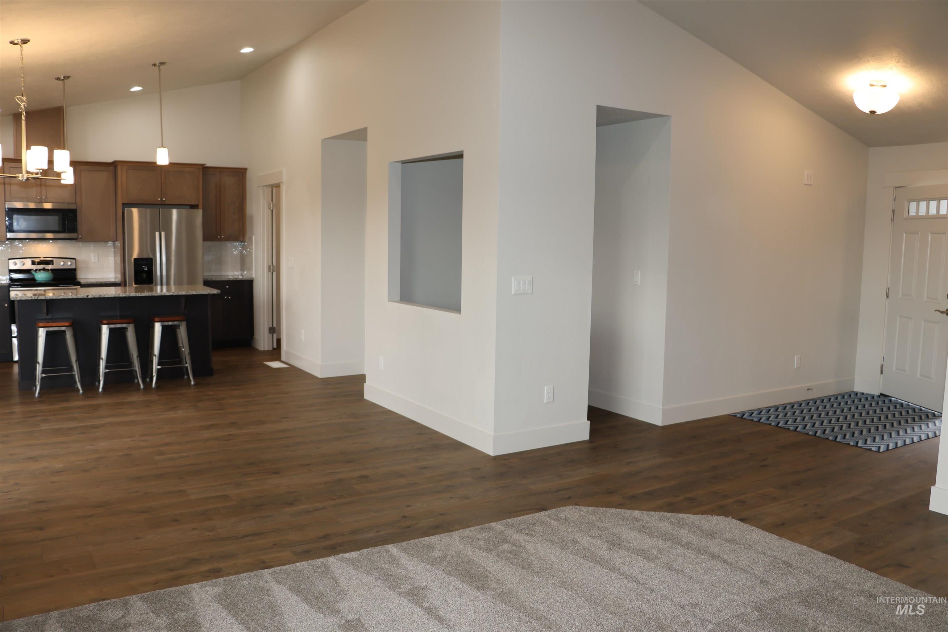 2272 Golf Lane Council, ID 83612 - Photo 10 of 32 Entrance foyer featuring dark wood-style floors, high vaulted ceiling, and recessed lighting