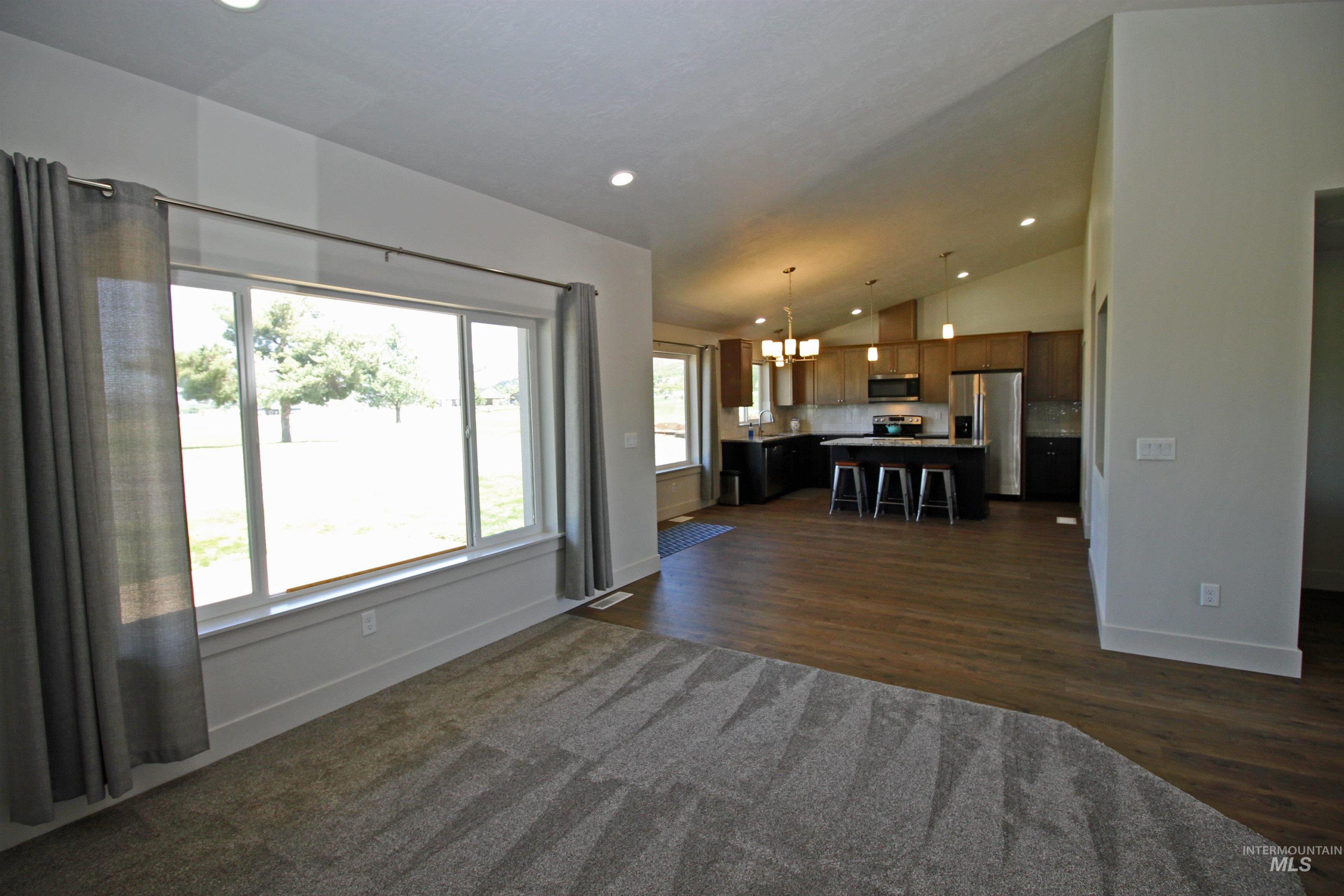 2272 Golf Lane Council, ID 83612 - Photo 11 of 32 Living area featuring vaulted ceiling, a chandelier, recessed lighting, and dark wood finished floors